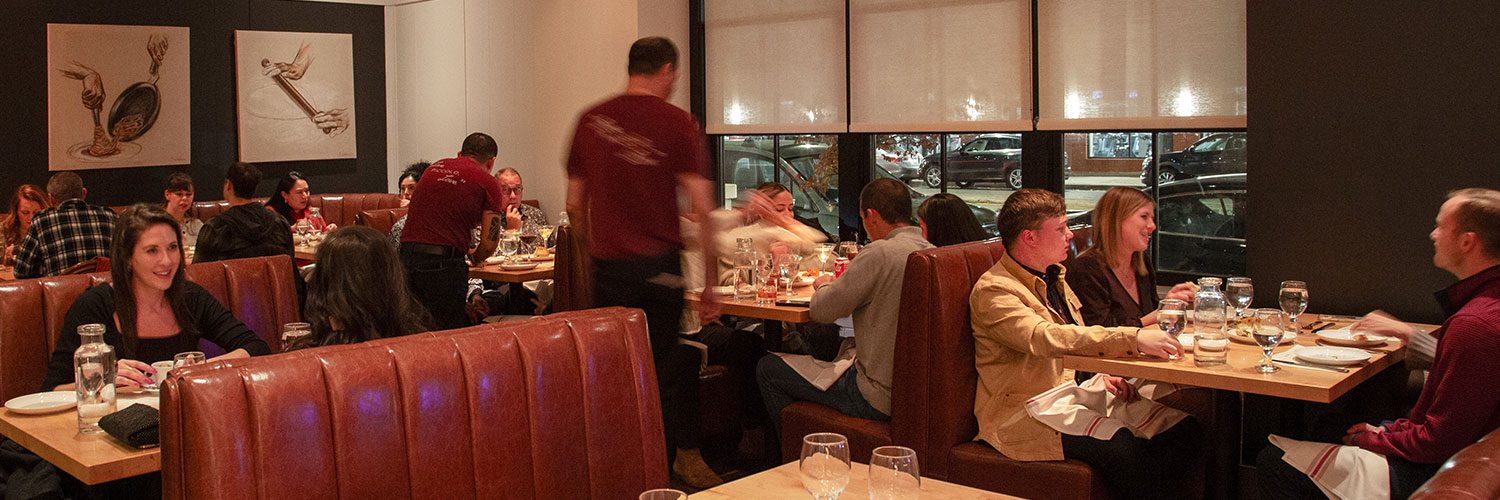 Gussie's busy restaurant in the evening with a view of a dining room